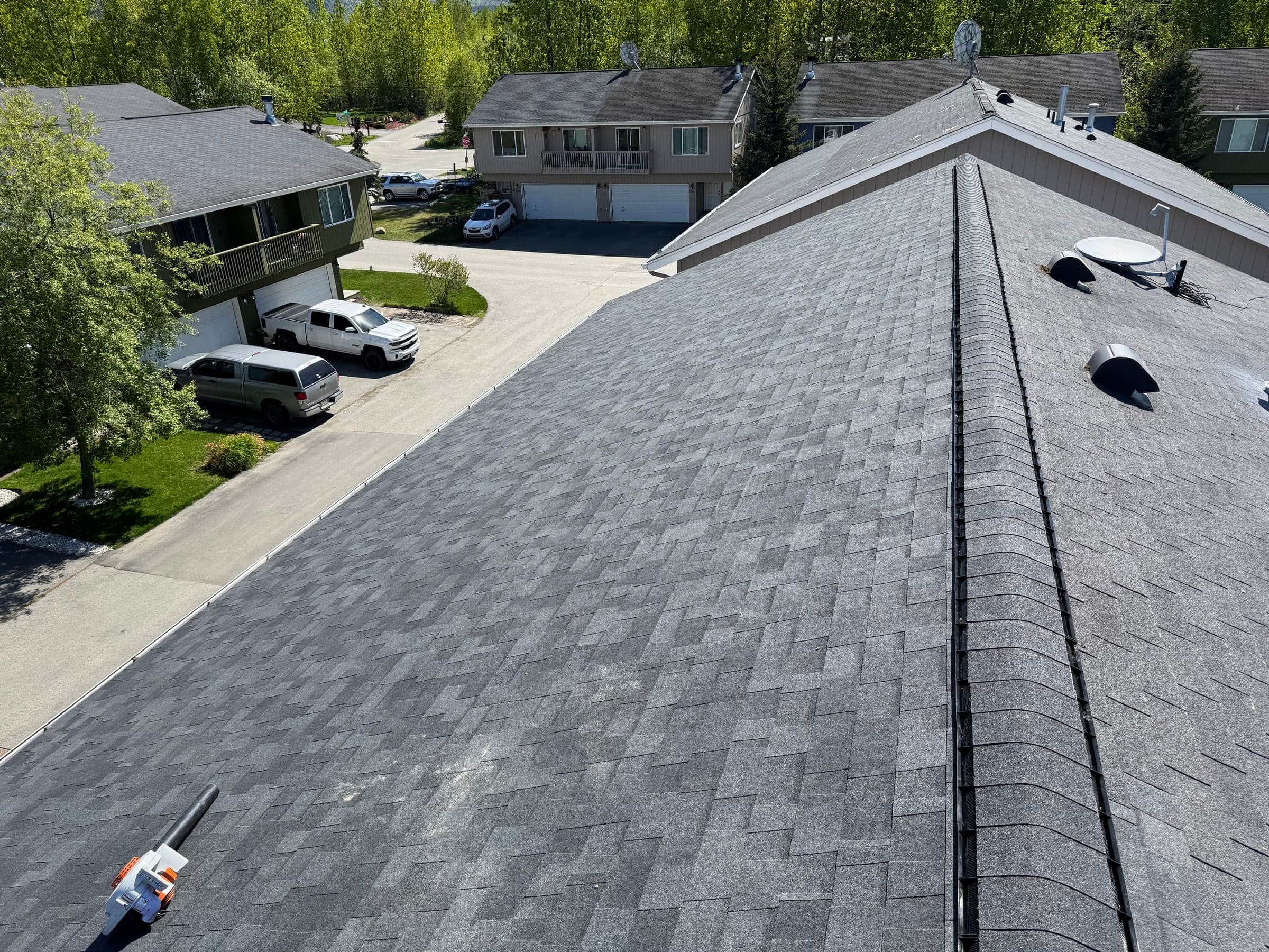 Finished architectural shingle roof by Black Spruce Roofing overlooking an Anchorage neighborhood