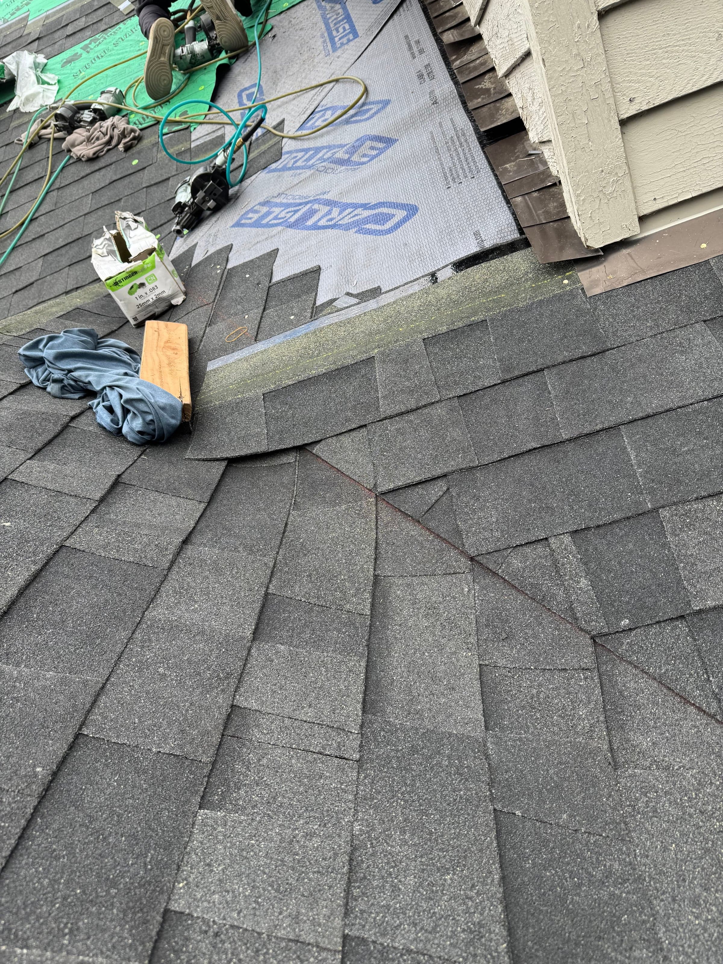 Step flashing and ice & water shield at a sidewall